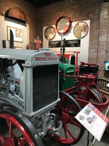 Photograph of a gray Minneapolis tractor at the American Tractor Museum
