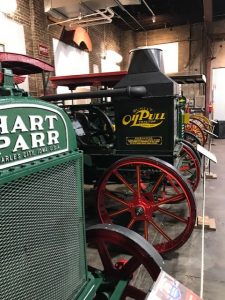 Photograph of a green tractor and a black tractor at the Amercian Tractor Museum